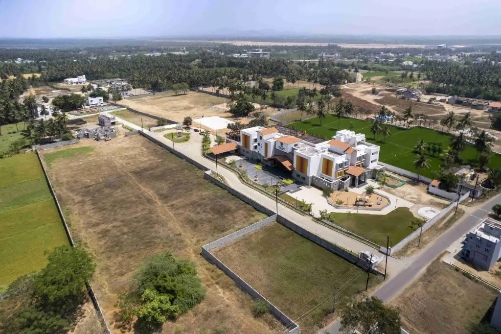 Modern villa complex in Kazhanipakkam, Vellore with green spaces and surrounding landscape.